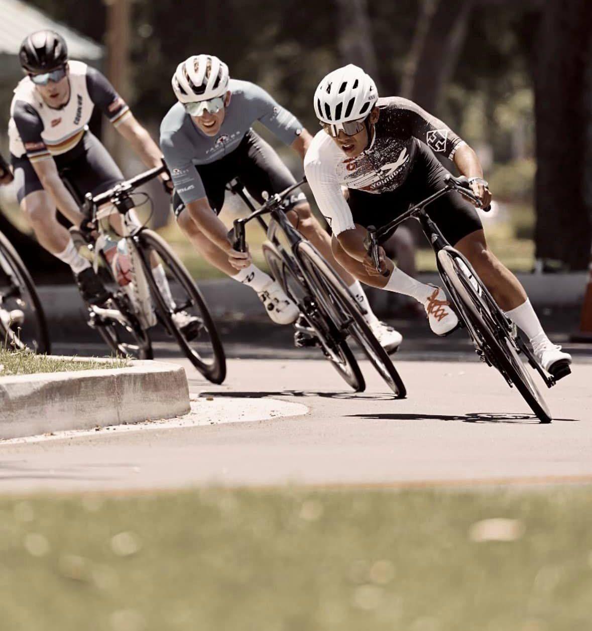 Experienced category riders cornering at speed